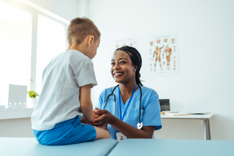 Female doctor with young boy patient