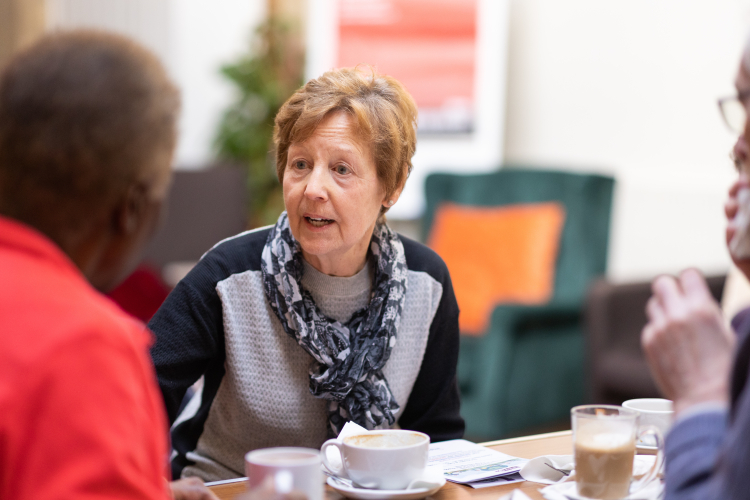 2 ladies talking over coffee