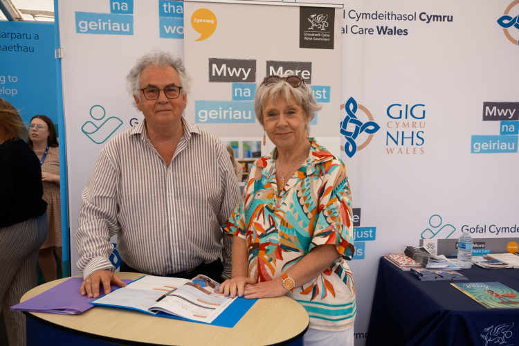 Our chair, Medwin Hughes, signing a pledge with mwy na geiriau team