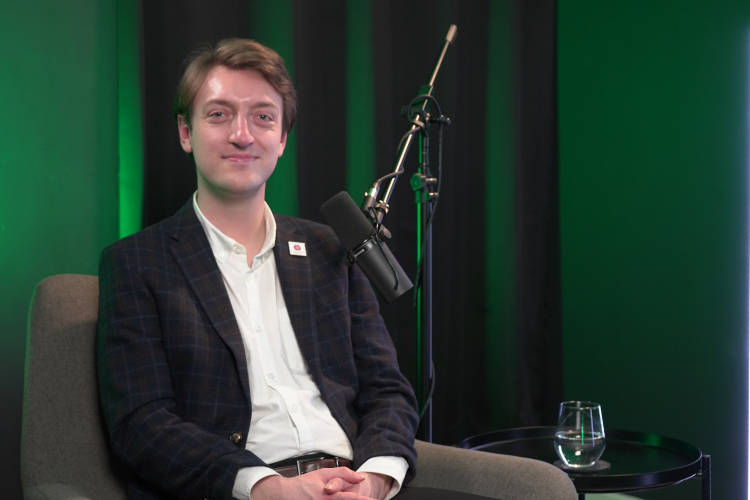 Jake Smith from Carers Wales sitting in a podcast studio