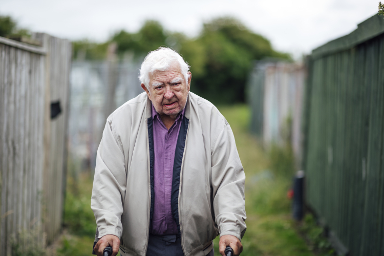 Senior man using mobility walker