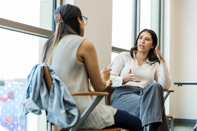 2 females sat having a discussion